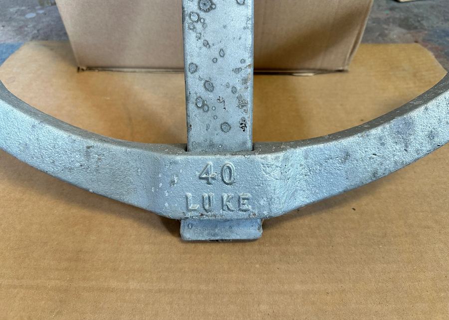 The number 40 and the word LUKE cast into the crown of a galvanized storm anchor.