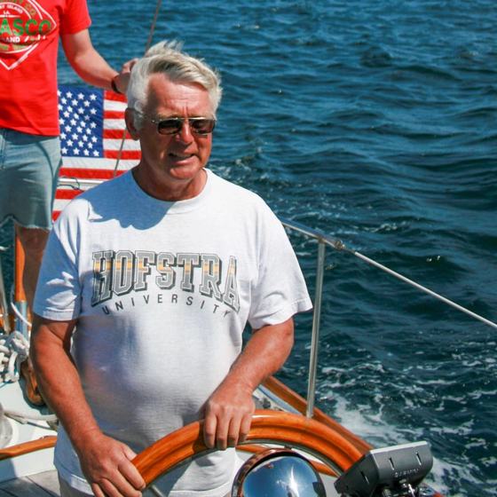 Frank Luke at the wheel of a sailboat under way.